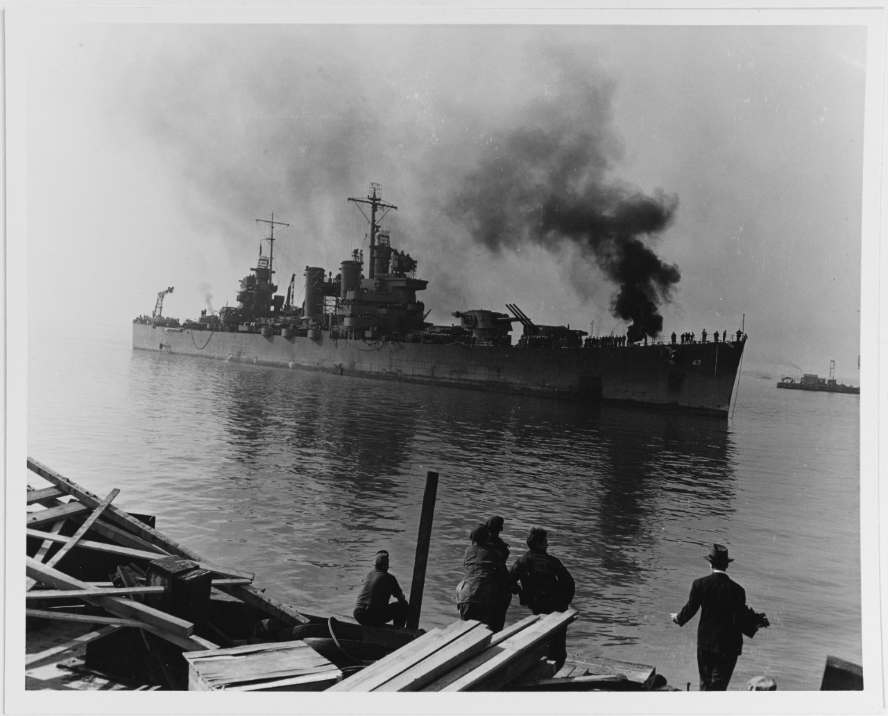USS Boise (CL-47) arrives at the Philadelphia Navy Yard in November 1942 for repair of battle damage received during the 11-12 October Battle of Cape Esperance. Note the forward 6/47 triple gun turret trained to starboard. It was jammed in this position during the action, when a Japanese 8 shell hit the armored barbette just below the turret. Official U.S. Navy Photograph, now in the collections of the National Archives.