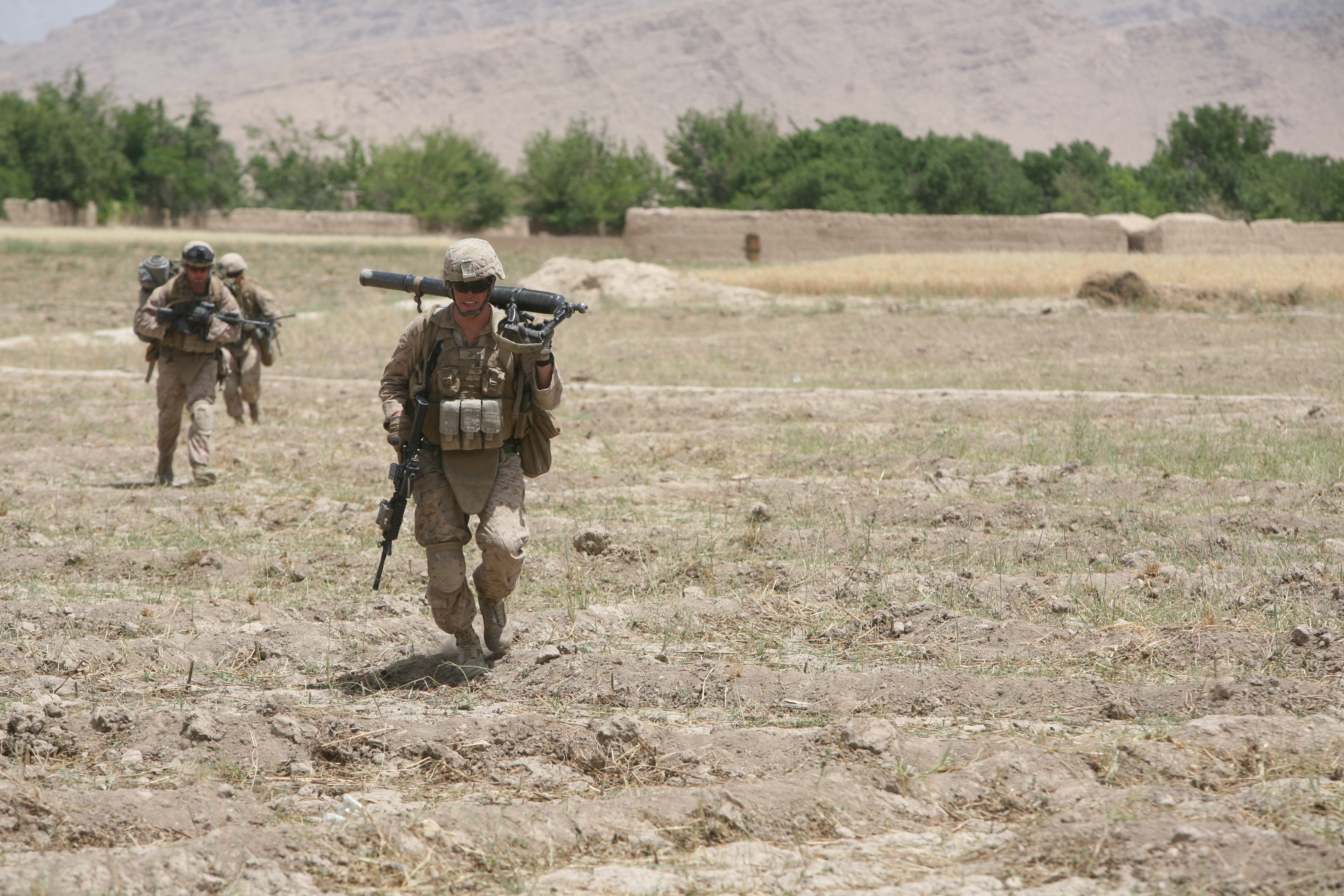 U.S. Marine Corps Lance Cpl. John R. Silvernail, front, with Golf Company, 2nd Battalion, 5th Marine Regiment, Regimental Combat Team 6 carries an M224 60 mm Lightweight Mortar as he runs for cover through an open field in Zamindawar, Helmand province, Afghanistan, May 28, 2012. Marines took enemy contact while they were conducting a patrol in the local area. (U.S. Marine Corps photo by Cpl. Christopher M. Paulton).