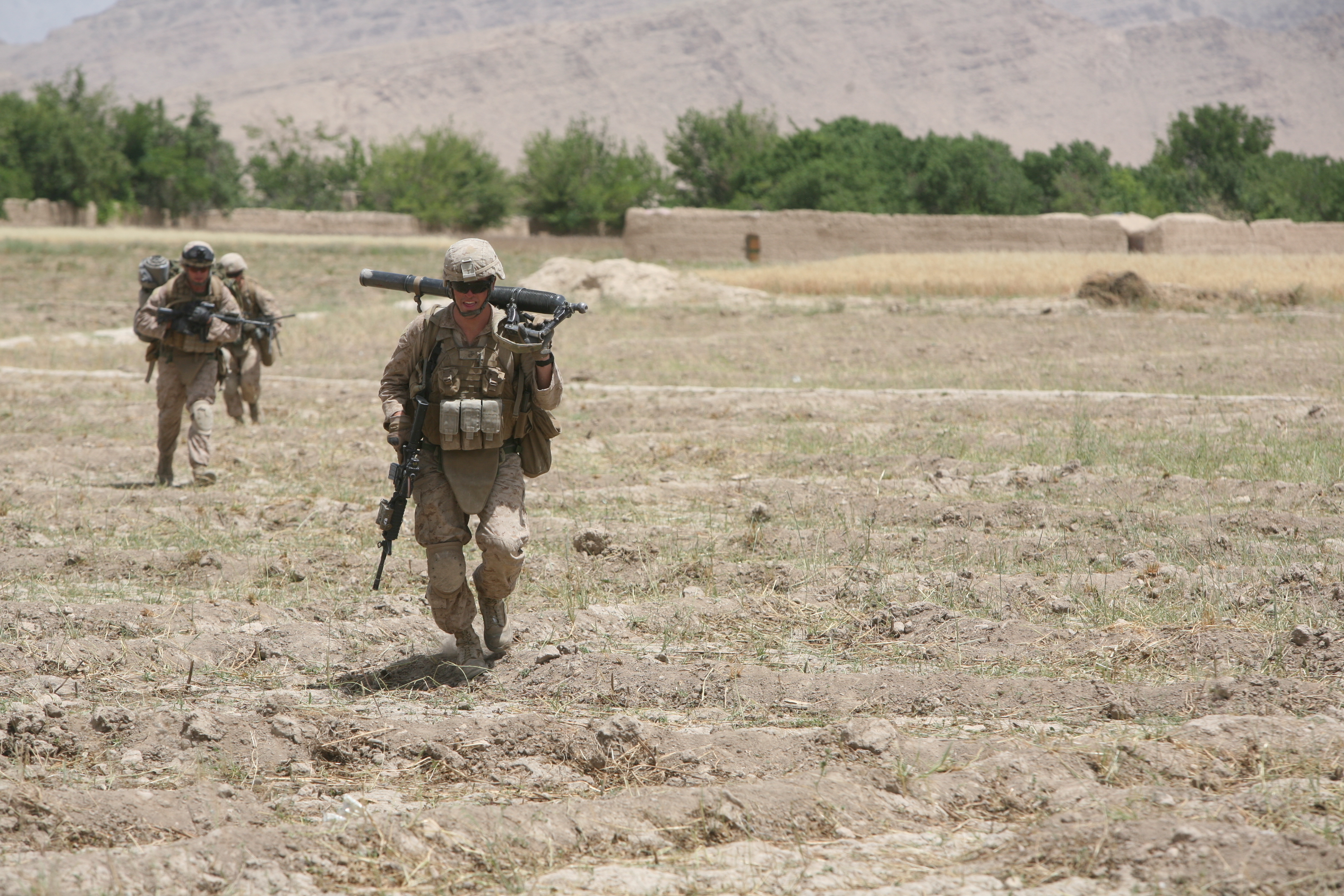 U.S. Marine Corps Lance Cpl. John R. Silvernail, front, with Golf Company, 2nd Battalion, 5th Marine Regiment, Regimental Combat Team 6 carries an M224 60 mm Lightweight Mortar as he runs for cover through an open field in Zamindawar, Helmand province, Afghanistan, May 28, 2012. Marines took enemy contact while they were conducting a patrol in the local area. (U.S. Marine Corps photo by Cpl. Christopher M. Paulton). U.S. Marine Corps Lance Cpl. John R. Silvernail, front, with Golf Company, 2nd Battalion, 5th Marine Regiment, Regimental Combat Team 6 carries an M224 60 mm Lightweight Mortar as he runs for cover through an open field in Zamindawar, Helmand province, Afghanistan, May 28, 2012. Marines took enemy contact while they were conducting a patrol in the local area. (U.S. Marine Corps photo by Cpl. Christopher M. Paulton).
