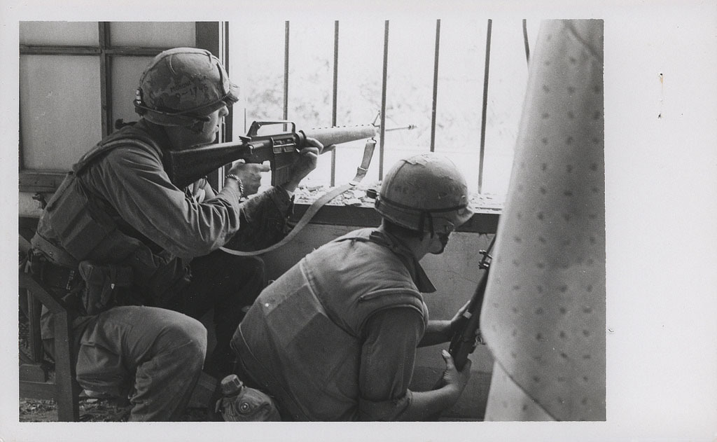 U.S. Marines with A Company, 1st Battalion, 1st Marines [A/1/1] return fire from a house window during a search and clear mission in the battle of Hue, Feb. 1968. (Official USMC photo by Sergeant Bruce A. Atwell, Marine Corps Archives & Special Collections).