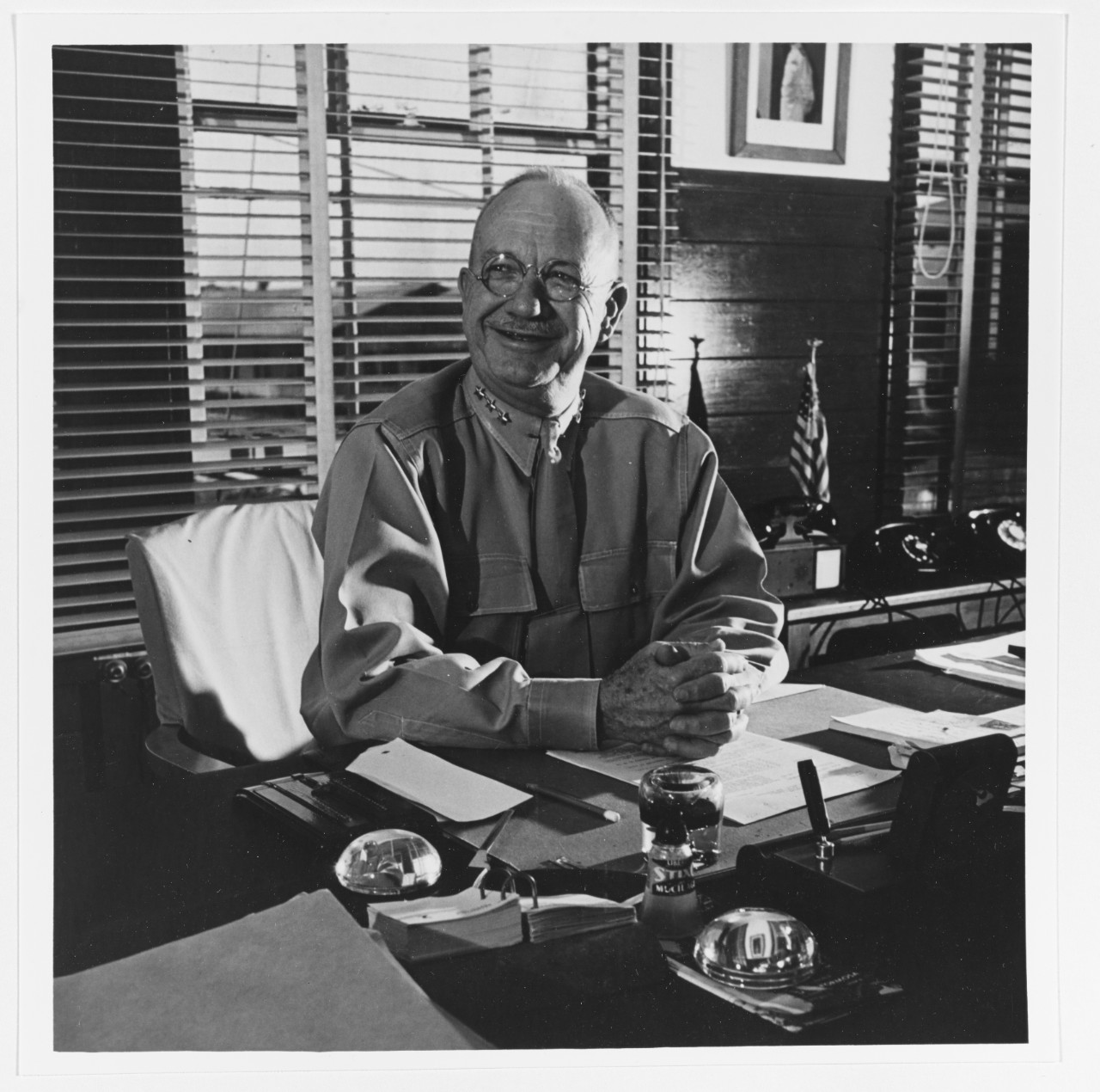 Lieutenant General Holland M. Smith, USMC Photographed in a genial mood at his desk, 30 April 1945. Site may be at the Pacific Fleet Advanced Headquarters on Guam. Official U.S. Navy Photograph, now in the collections of the National Archives.
